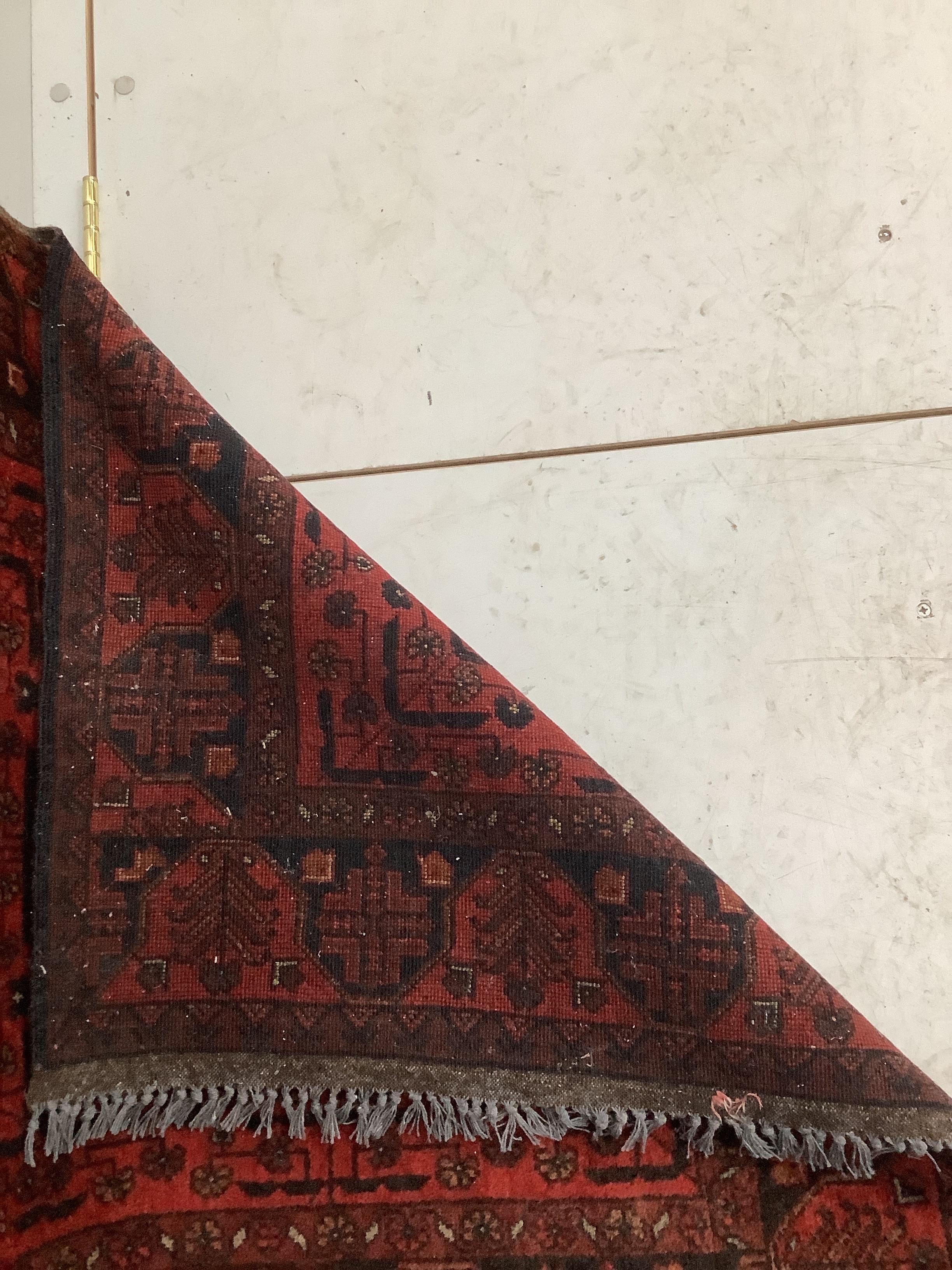 An Afghan red ground runner, 290 x 85cm